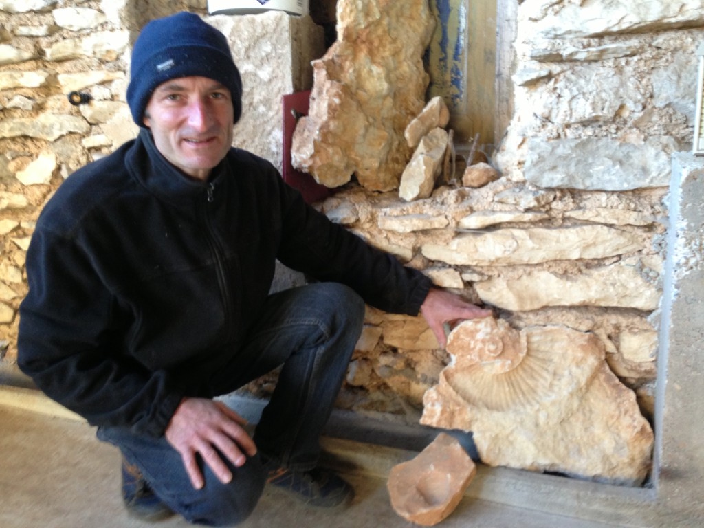 Eric with a myriad of 250 million old fossils he found while rototilling his land